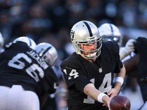 Expect to see Oakland Raiders quarterback Matt McGloin doing this a lot against the Broncos on Sunday: Handing off the football. (GETTY IMAGES)