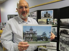 Wayne Wager, chairperson of the Sarnia Heritage Committee, is pictured here in 2012 with a display of historic photos, including one of the former Gurd House. File photo/Sarnia Observer/Postmedia Network