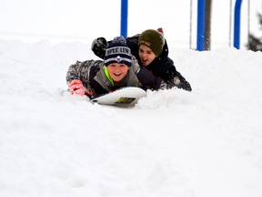 Dylan Follett (left) ended up with a surprise passenger on his snow surfer as his brother Brayden jumped on for the ride during a recent trip down the Lions Park hill in Mitchell, taking advantage of snow and perfect weather conditions. With school not resuming until Jan. 9, there’s still more time to take advantage of the hill and other indoor/outdoor activities to keep kids occupied. Some snow had melted over Christmas, making travelling easier, but one can be sure more snow will be forthcoming now that winter is officially here! GALEN SIMMONS/MITCHELL ADVOCATE