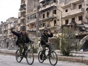 Syrian regime forces flash the "V" for victory sign in the former rebel-held Sukkari district in the northern city of Aleppo on December 23, 2016 after Syrian government forces retook control of the whole embattled city. Syrian troops cemented their hold on Aleppo after retaking full control of the city, as residents anxious to return to their homes moved through its ruined streets.   George OURFALIANGEORGE OURFALIAN/AFP/Getty Images