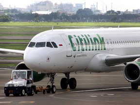 A Citilink passenger plane from the budget arm of Indonesian flag carrier Garuda parks on the tarmac of the Soekarno-Hatta International Airport in Tangerang outside Jakarta in this Jan. 3, 2013 file photo. (FAJRIN/AFP/Getty Images)