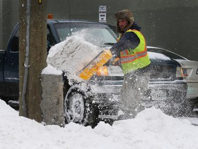 City of Ottawa workers busy clearing the sidewalk snow.