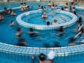 Visitors enjoy a bath in a pool of Szechenyi Thermal Bath and Swimming Pool in Budapest, Hungary. The city of Budapest has centuries of experience with the art of relaxation, thanks to its public baths, where you can sink neck-deep in hot mineral waters. (Zoltan Balogh/MTI via AP, file)