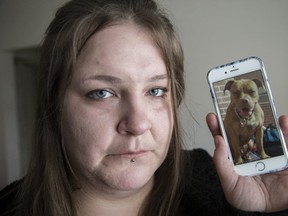 Trudy Jennings holds a picture of her stolen dog, Lava. (CRAIG ROBERTSON, Toronto Sun)