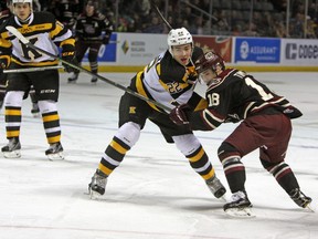 Peterborough Petes Adam Timleck tries to battle past  Kingston Frontenacs defenceman Jakob Brahaney during the first period of Ontario Hockey League action at the Rogers K-Rock Centre in Kingston, Ont. on Friday December 30, 2016. Steph Crosier/Kingston Whig-Standard/Postmedia Network