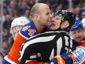 Edmonton Oilers' Zack Kassian is held back by a referee while playing against the Tampa Bay Lightning at Rogers Place onDec. 17. (The Canadian Press)