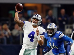 Cowboys QB Dak Prescott (4) throws a pass as Lions' Ezekiel Ansah (94) pressures during NFL action in Arlington, Texas on Dec. 26, 2016. (Brandon Wade/AP Photo)