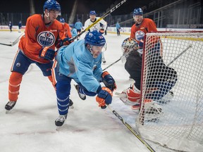 Ryan Nugent-Hopkins is pushed from behind by Brandon Davidson as the Edmonton Oilers practice at Rogers Place leading up to a New Year's Eve game against the Vancouver Canucks. (Shaughn Butts)