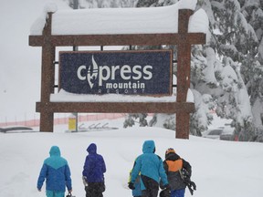 People arrive at the Cypress Mountain resort in West Vancouver, Thursday, Dec.29, 2016. Rescue teams on Vancouver's North Shore are on standby, hoping a break in the weather and a reduced avalanche risk will allow them to resume a search for two missing snowshoers. (THE CANADIAN PRESS/Jonathan Hayward)