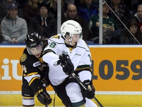 London Knights forward Liam Foudy keeps Sarnia Sting defenceman Jeff King at bay as he skates the puck into the offensive zone during their OHL ice hockey game at Budweiser Gardens in London, Ont. on Friday December 30, 2016. (CRAIG GLOVER, Postmedia Network)