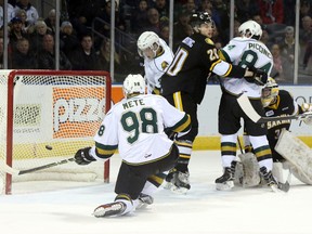 London Knights defenceman Victor Mete shoots the puck into the back of the net as Sarnia Sting goaltender Justin Fazio is kept from his net by Sting defenceman and Knights forward JJ Piccinich during their OHL ice hockey game at Budweiser Gardens in London, Ont. on Friday December 30, 2016. (CRAIG GLOVER, The London Free Press)
