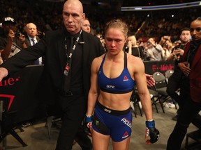 Ronda Rousey exits the Octagon after her loss to Amanda Nunes of Brazil in their UFC women's bantamweight championship bout during the UFC 207 event on December 30, 2016 in Las Vegas, Nevada. (Christian Petersen/Getty Images)