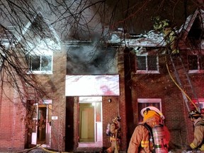 Firefighters were working to quell a fire that broke out in a Centretown row house early Saturday. Scott Stilborn photo