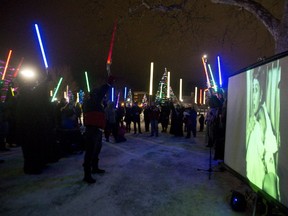 Fans of Carrie Fisher lift their lightsabers to the sky in tribute to the actor, who famously played Princess Leia in the Star Wars franchise and passed away this week, during a memorial and march in Victoria Park in London, Ont. on Friday December 30, 2016. About 75 fans listened to speeches, watched a slideshow of photographs taken throughout Fisher's life, and shared fond memories of the actress and her work. Craig Glover/The London Free Press/Postmedia Network