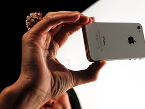 An Apple Inc. employee demonstrates FaceTime, a video chat application on the newly-announced iPhone 4, in San Francisco in this June 7, 2010 file photo. (Ryan Anson/AFP/Getty Images)