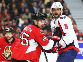 Senators captain Erik Karlsson (left) tightly checks Capitals captain Alex Ovechkin during NHL action in Ottawa last March. The Senators face the Capitals in Washington on Jan. 1. (Jean Levac/Postmedia/Files)