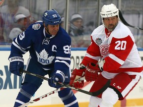 Doug Gilmour of the Maple Leafs Alumni battles for position against Martin Lapointe of the Red Wings Alumni during the Centennial Classic Alumni Game at Exhibition Stadium in Toronto on Saturday, Dec. 31, 2016. (Dave Abel/Toronto Sun)