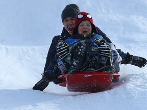 A father and son duo make a toboggan run at The Forks in Winnipeg on Sat., Dec. 31, 2016. Kevin King/Winnipeg Sun/Postmedia Network