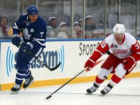 Gary Roberts of the Maple Leafs Alumni chips the puck past Kris Draper of the Red Wings Alumni during the Centennial Classic Alumni Game at Exhibition Stadium in Toronto on Saturday, Dec. 31, 2016. (Dave Abel/Toronto Sun)