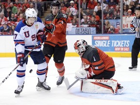 U.S. forward Jeremy Bracco (17) corrals a loose puck before scoring against Canada goaltender Connor Ingram (1) as forward Pierre-Luc Dubois (18) defends during second period world junior hockey championship action in Toronto on Saturday, Dec. 31, 2016. (Nathan Denette/The Canadian Press)