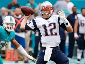 Patriots quarterback Tom Brady (12) aims to pass during NFL action against the Dolphins in Miami Gardens, Fla., on Sunday, Jan. 3, 2016. (Wilfredo Lee/AP Photo)