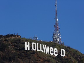 The Hollywood sign is seen vandalized Sunday, Jan. 1, 2017. Los Angeles residents awoke New Year's Day to find a prankster had altered the famed Hollywood sign to read "HOLLYWeeD." (AP Photo/Damian Dovarganes)