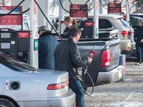 Alberta's carbon tax kicks in on Jan. 1 and some  Edmontonians were lining up at Costco gas pumps in advance to save that 4.5 cents one more time on December 31, 2016. (Shaughn Butts/Postmedia)