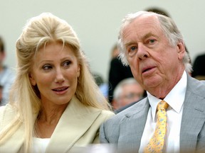 In this July 25, 2006, file photo, Oklahoma energy tycoon T. Boone Pickens, right, with his wife, Madeleine, appear at a House Energy and Commerce subcommittee hearing on Capitol Hill in Washington. A federal lawsuit accuses Madeleine Pickens, the ex-wife Pickens, of racial discrimination at her rural Nevada dude ranch. (AP Photo/Dennis Cook, File)