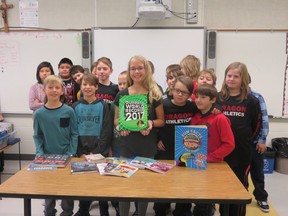 Megan Bruder, Grade 5, and her classmates show off the books she purchased with her Youth in Action Grant. | Contributed photo/Pincher Creek & District Municipal Library