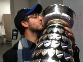 Vince Flamia embraces the Yates Cup after the Wilfrid Laurier Golden Hawks stunned the Western Mustangs 43-40 Nov. 12 in London. Flamia, a 30-year-old Sarnia native, was Laurier's defensive backs and special teams assistant coach. (Handout/Sarnia Observer/Postmedia Network)