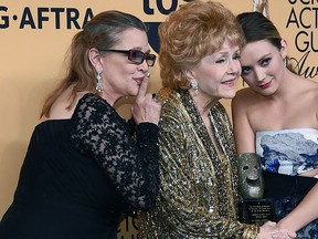 Carrie Fisher, Debbie Reynolds and Billie Lourd pose in the press room during the 21st Annual Screen Actors Guild Awards at The Shrine Auditorium on Jan. 25, 2015 in Los Angeles.  (Ethan Miller/Getty Images)