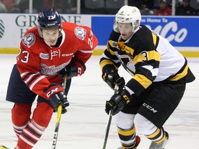 Kingston Frontenacs’ Warren Foegele and Oshawa Generals’ Jack Studnicka battle for the puck during Ontario Hockey League action at the Rogers K-Rock Centre on Dec. 17. The Frontenacs traded Foegele to the Erie Otters on Monday. (Steph Crosier/The Whig-Standard)
