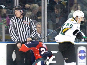 Cole Carter of the Windsor Spitfires crashes into a linesman after bouncing off London Knight Alex Forementon at Budweiser Gardens in November. (DEREK RUTTAN, The London Free Press)