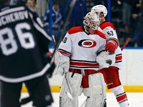 Carolina Hurricanes emergency backup goalie Jorge Alves is given the game puck by Jeff Skinner following his NHL debut on Dec. 31, 2016. (AP Photo/Mike Carlson)