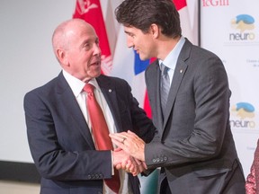 Maple Leaf Sports & Entertainment's Larry Tanenbaum is thanked by Justin Trudeau after his speech at the Montreal Neurological Institute on Dec. 16, 2016. (THE CANADIAN PRESS/Ryan Remiorz)