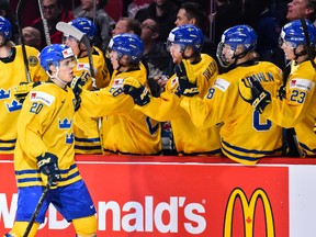 Joel Eriksson Ek of Team Sweden celebrates his first period goal with teammates on the bench during the 2017 IIHF World Junior Championship quarterfinal game Team Slovakia at the Bell Centre on Jan. 2, 2017. (Minas Panagiotakis/Getty Images)