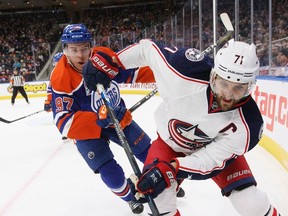 Columbus Blue Jackets' Nick Foligno is chased by Edmonton Oilers captain Connor McDavid at Rogers Place on Dec. 13, 2016.