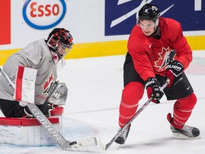 Graham Hughes/The Canadian Press
Team Canada goaltender Carter Hart makes a save against teammate Julien Gauthier during practice Sunday, ahead of their quarter-final round match against the Czech Republic.