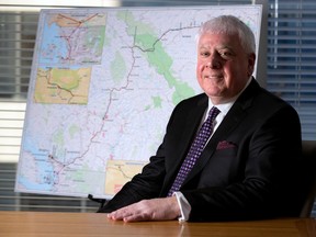 Ian Anderson, President of Kinder Morgan Canada, was photographed in the company's Calgary office in front of a map of the Trans Mountain pipeline route on December 20, 2016. (GAVIN YOUNG/POSTMEDIA)