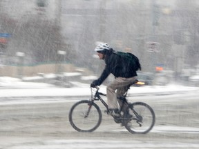 A biker braves the freezing rain.