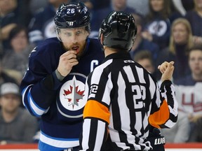 Winnipeg Jets' Blake Wheeler shows the referee the results of a high stick by a New York Islanders player during Saturday night's game. The Jets are hoping for a better performance Tuesday night in Tampa. (THE CANADIAN PRESS/John Woods)