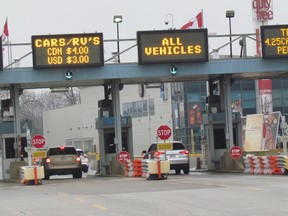 Drivers stop at the toll booths on Tuesday January 3, 2017 at the Blue Water Bridge in Point Edward, Ont. The launch of a new commuter discount program for frequent bridge users has been delayed. The bridge stopped selling discount toll tokens in April. (Paul Morden/Sarnia Observer/Postmedia Network)