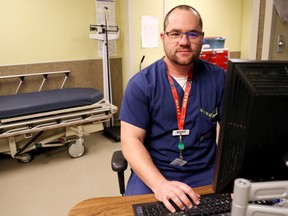 Luke Hendry/The Intelligencer
Registered nurse Scott Simmons sits in a triage area of the Belleville General Hospital emergency department Tuesday. The holidays are a busy time for such departments and Quinte Health Care staff and doctors are asking patients to visit only in emergencies or when care isn't available from other providers.