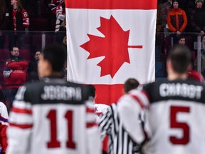 The Canadian flag is raised after Team Canada's victory over Team Czech Republic during the 2017 IIHF World Junior Championship quarterfinal game at the Bell Centre on Jan. 2, 2017. (Minas Panagiotakis/Getty Images)