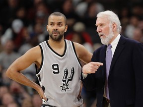 San Antonio Spurs head coach Gregg Popovich talks with guard Tony Parker during the second half of an NBA game against the Portland Trail Blazers on Dec. 30, 2016. (AP Photo/Eric Gay)