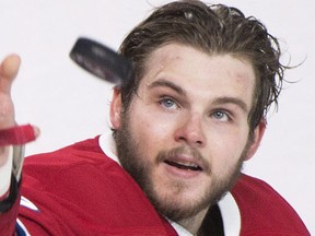 Montreal Canadiens' Alex Galchenyuk throws a puck to fans following the Canadiens win over the Tampa Bay Lightning in an NHL hockey game in Montreal, Saturday, April 9, 2016. (THE CANADIAN PRESS/Graham Hughes)