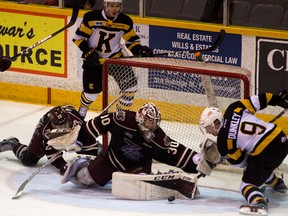 Kingston Frontenacs' Nathan Dunkley gets his stick caught behind the skate of Petes goalie Dylan Wells during an OHL game in Peterborough on Tuesday night. The Petes won 3-1. (Jessica Nyznik/Postmedia Network)
