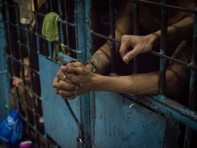 Inmates stay inside an overcrowded jail cell inside a police precint jail in this December 15, 2016 file photo taken in Manila, Philippines. (Dondi Tawatao/Getty Images)