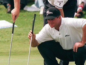 In this file picture taken on Nov. 24, 1996, South African golfers Ernie Els (top) and Wayne Westner discuss tactics on a green during the 1996 World Cup at Erinvale, Somerset West, outside Cape Town. (AFP PHOTO)