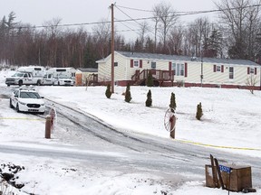 Police vehicles are seen outside a residence in Upper Big Tracadie, N.S., on Wednesday, Jan. 4, 2017. RCMP said four bodies were found inside the home in northeastern Nova Scotia saying the public was not at risk. (THE CANADIAN PRESS/Andrew Vaughan)
